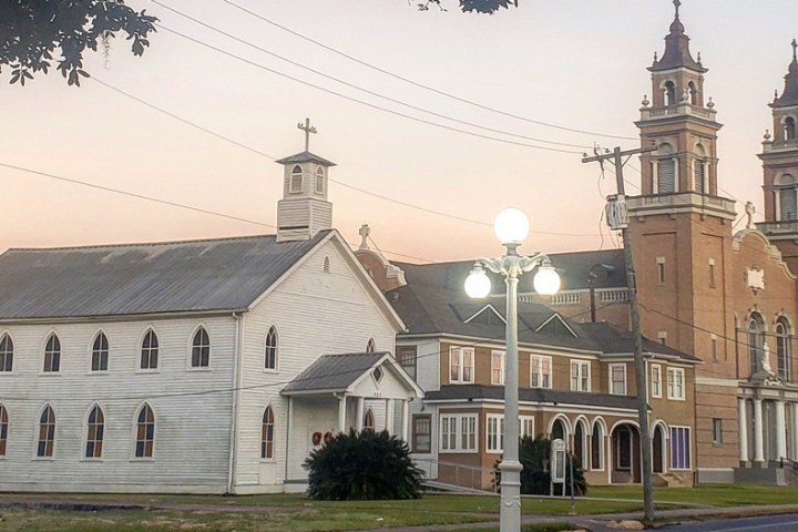 a small clock tower in front of a house